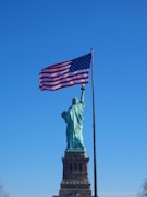 the statue of liberty is holding the american flag