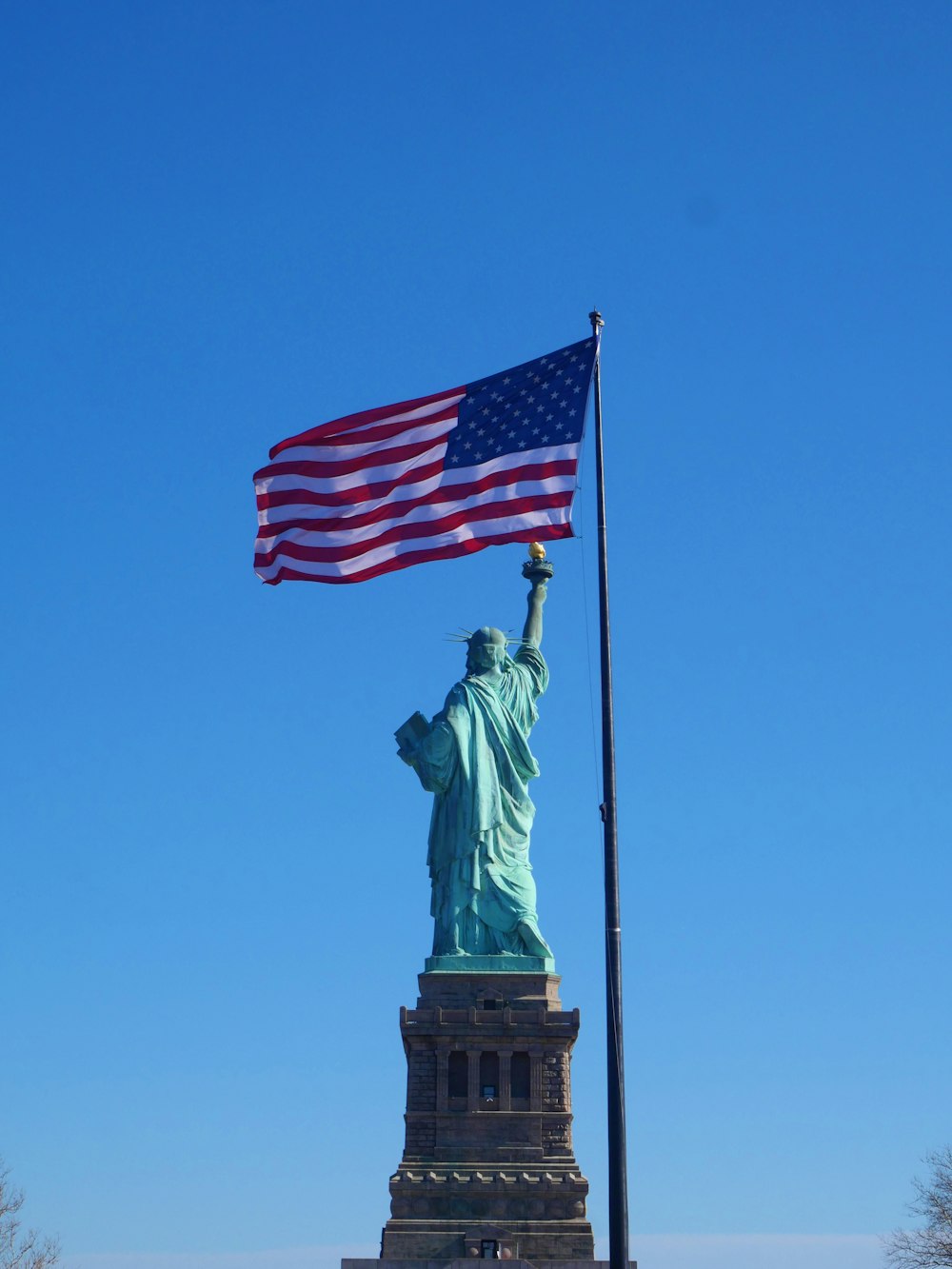 the statue of liberty is holding the american flag