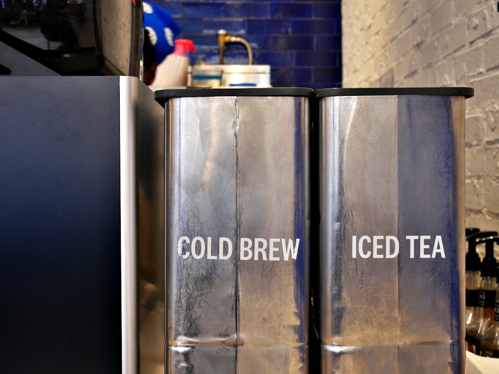 a couple of metal containers sitting on top of a counter