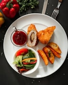 a white plate topped with meat and vegetables