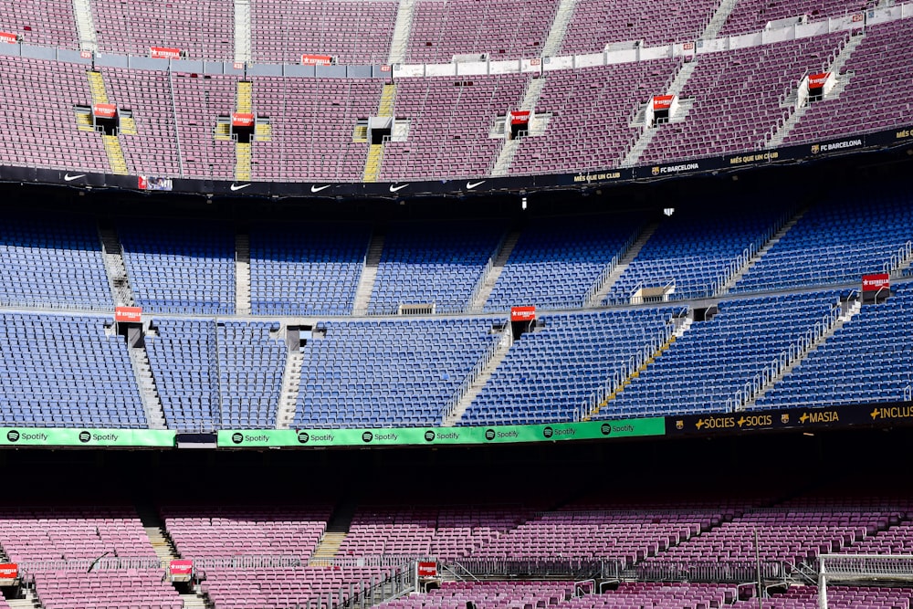 A stadium filled with lots of purple and blue seats photo – Free Spain  Image on Unsplash