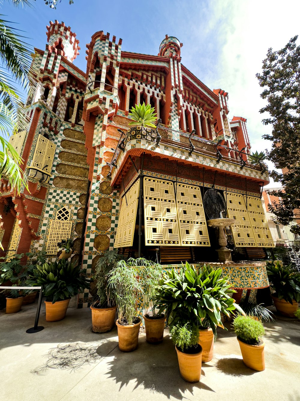 a building that has a bunch of plants in front of it