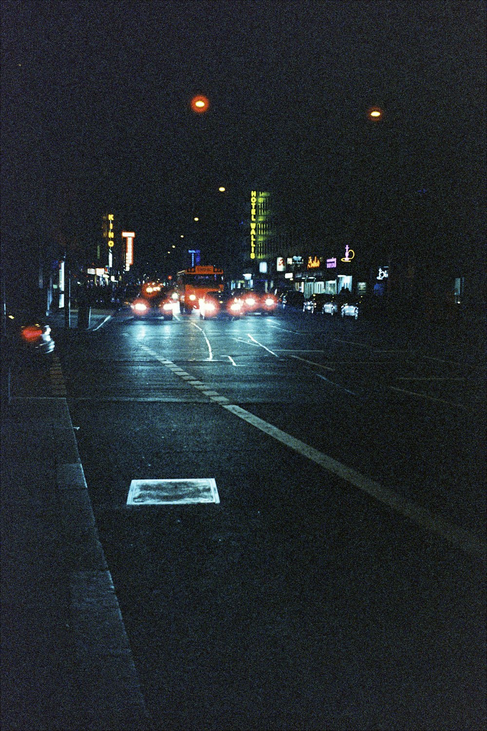 a city street at night with a lot of traffic