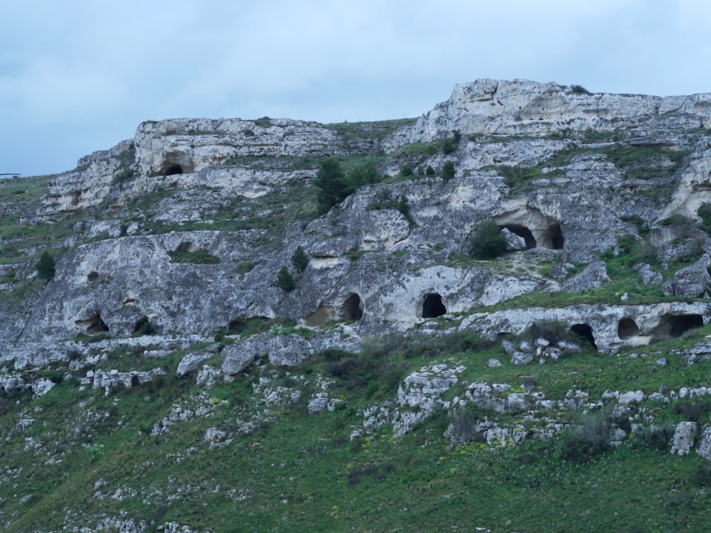 a large rock formation with caves on top of it
