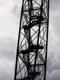 a very tall metal structure with a sky in the background