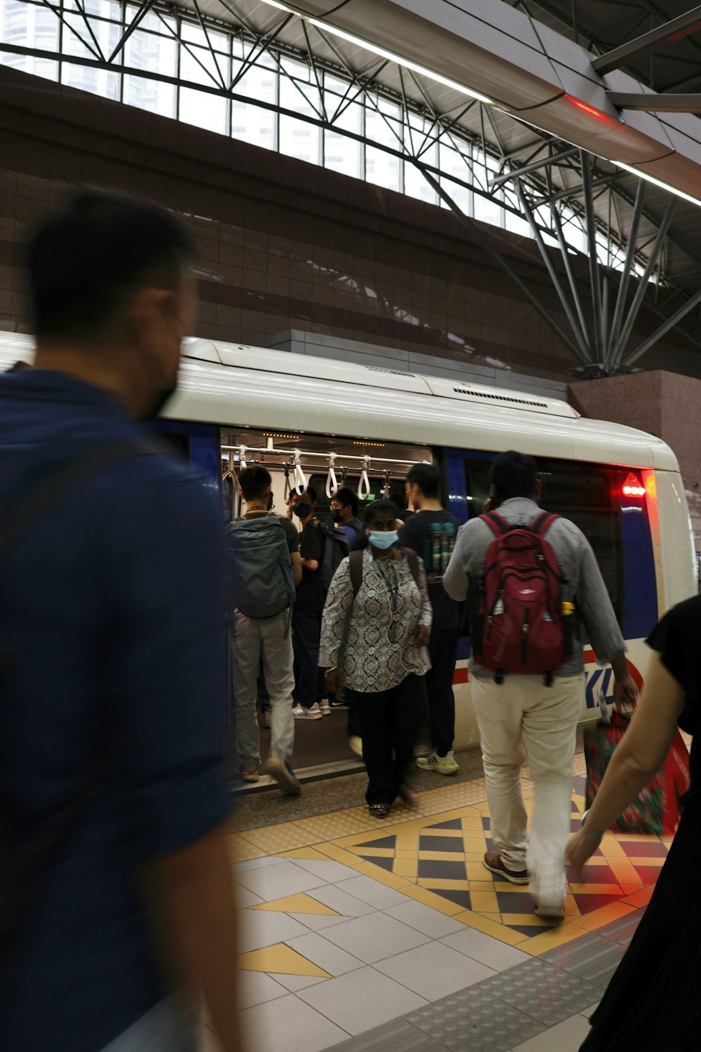 a group of people standing next to a train