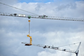 a crane is lifting a piece of equipment into the air