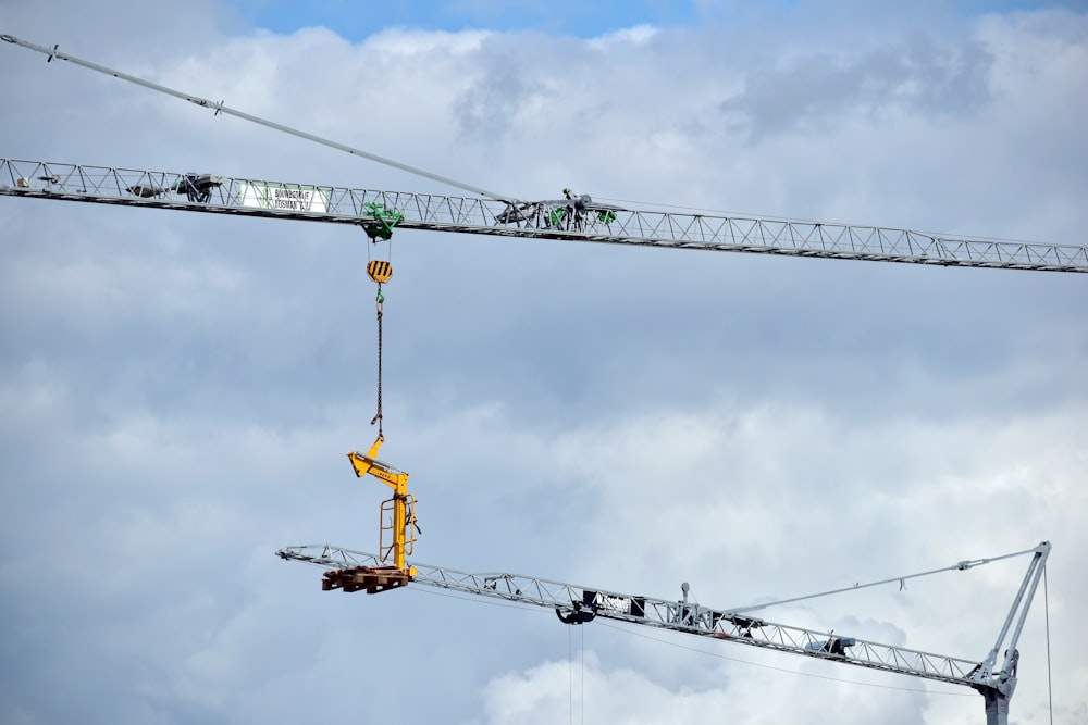 a crane is lifting a piece of equipment into the air