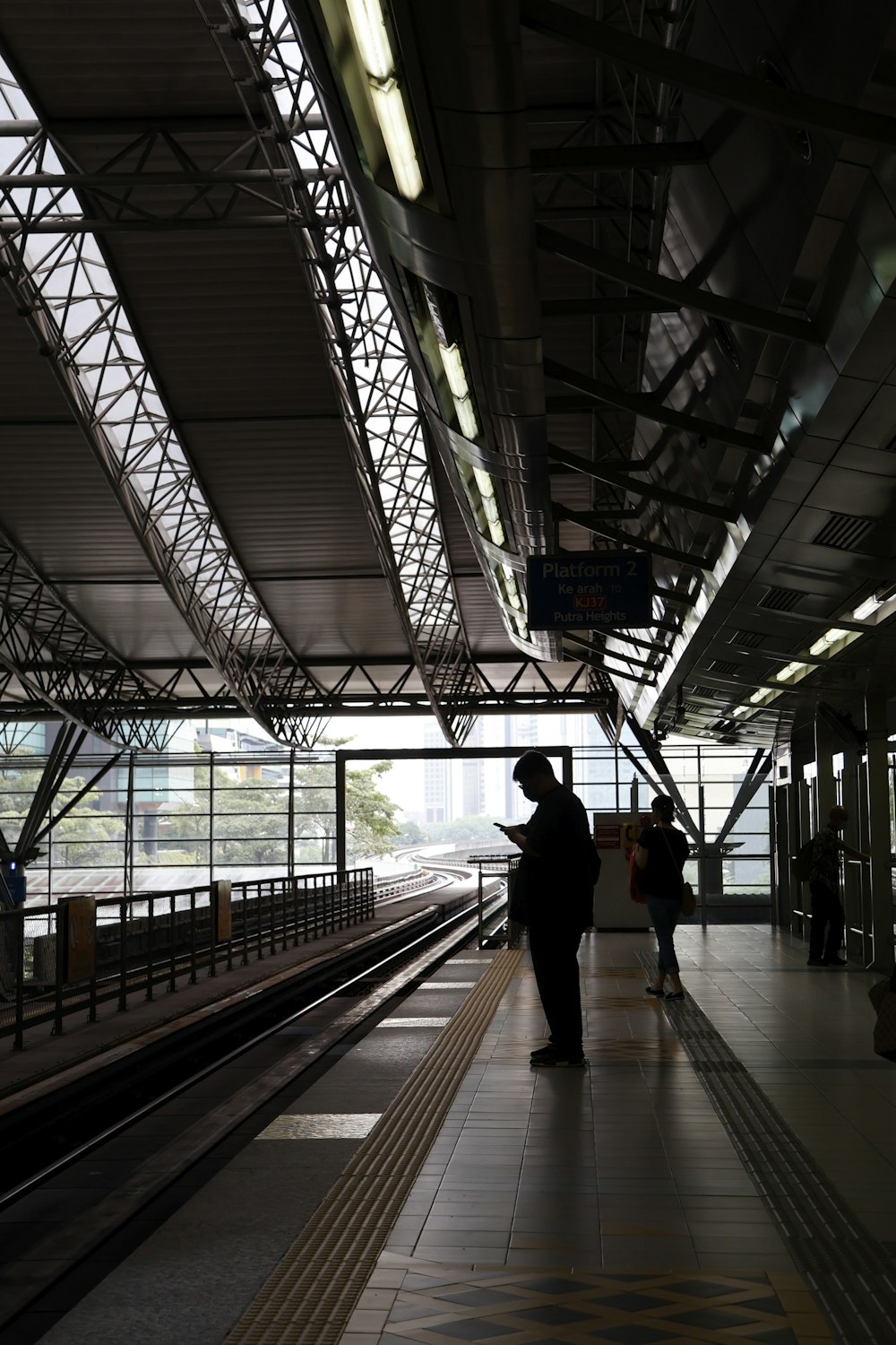 a train station with people waiting for the train