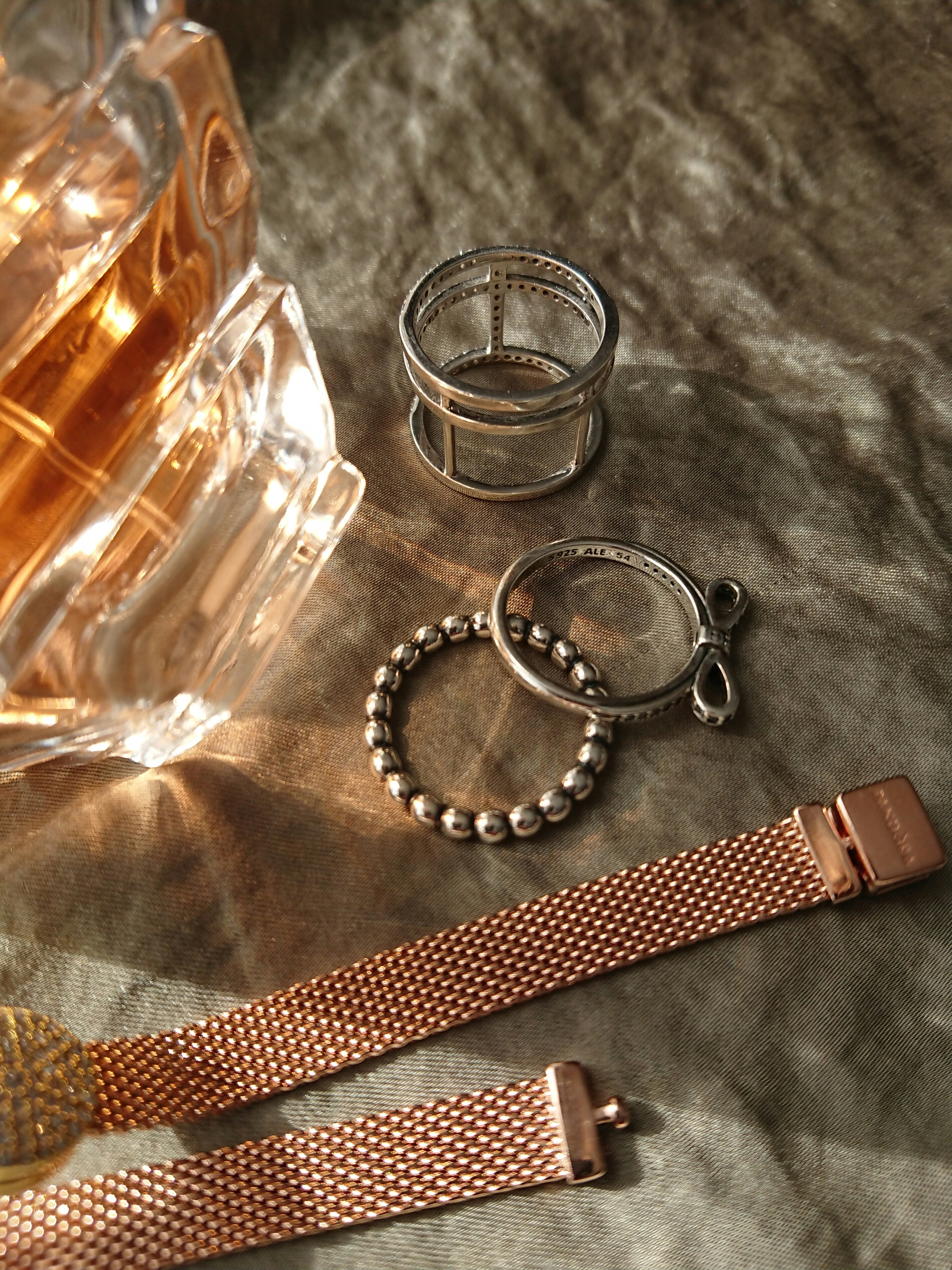 a couple of rings and a bracelet on a table