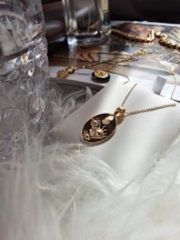 Elegant gold necklace with a delicate pendant displayed on a white surface