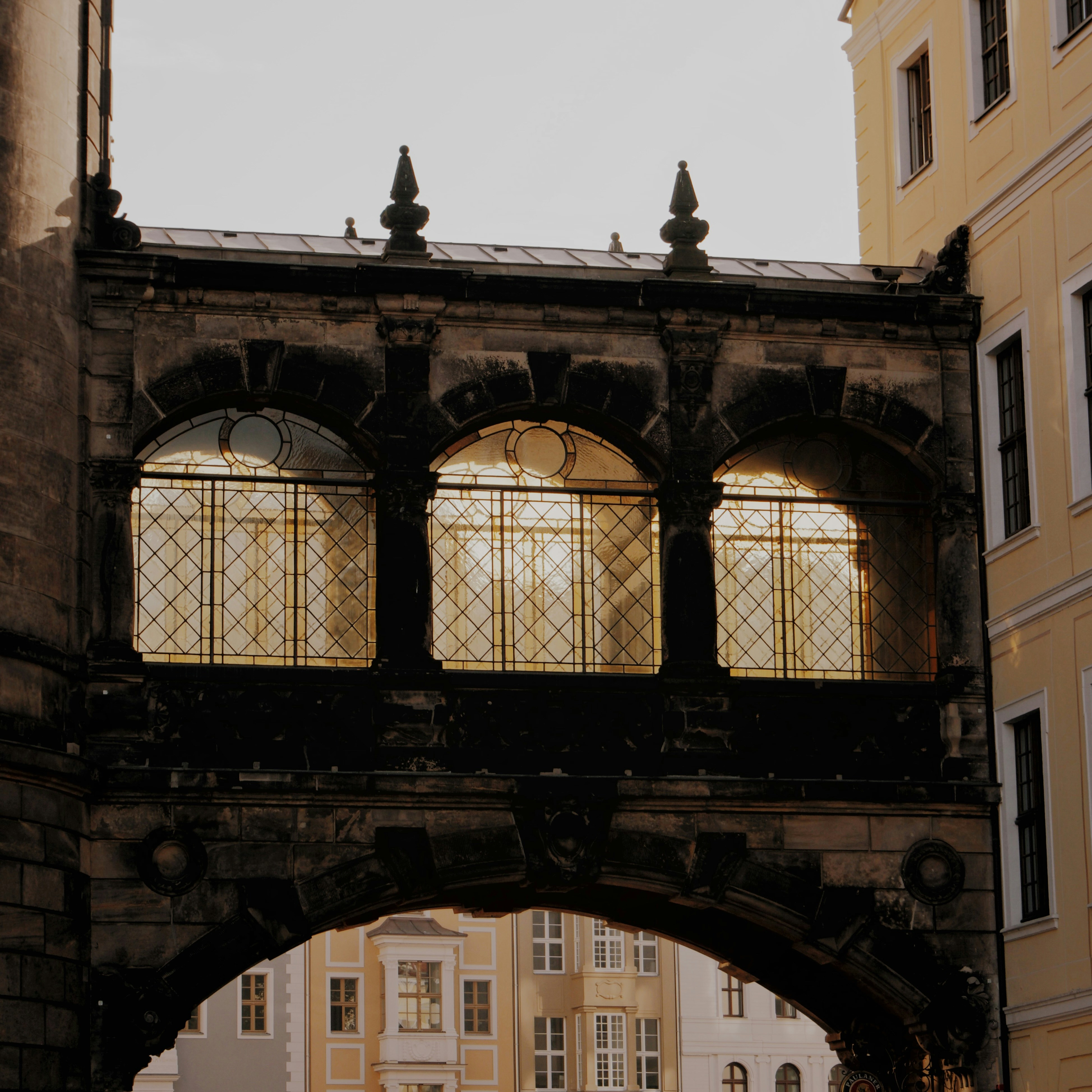 a couple of people walking under a bridge