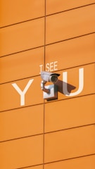 a security camera mounted to the side of a building