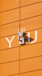a security camera mounted to the side of a building