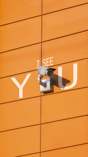 a security camera mounted to the side of a building
