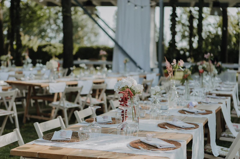 Long tables dressed for an outdoor wedding reception