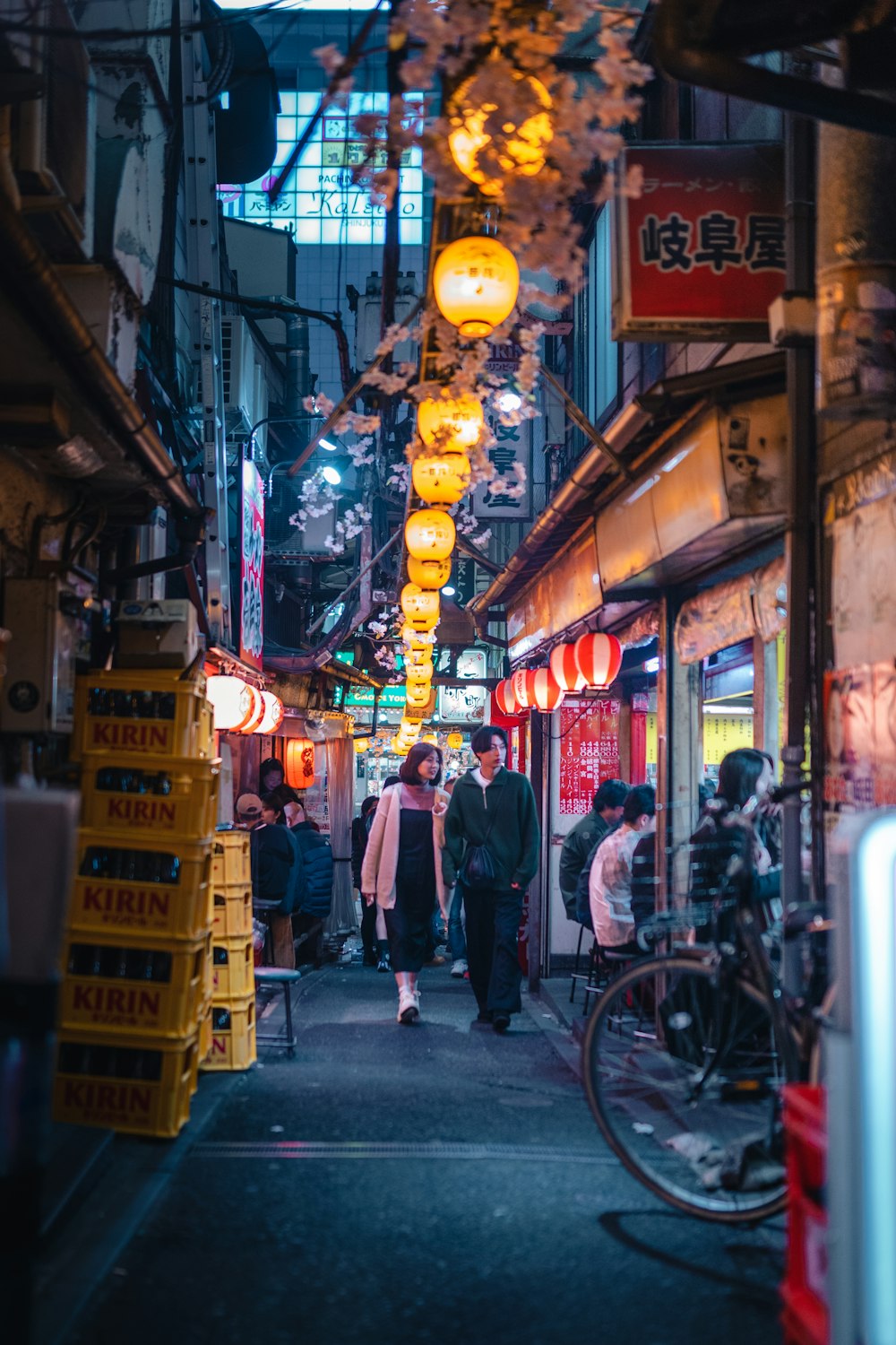 a narrow street with people walking down it