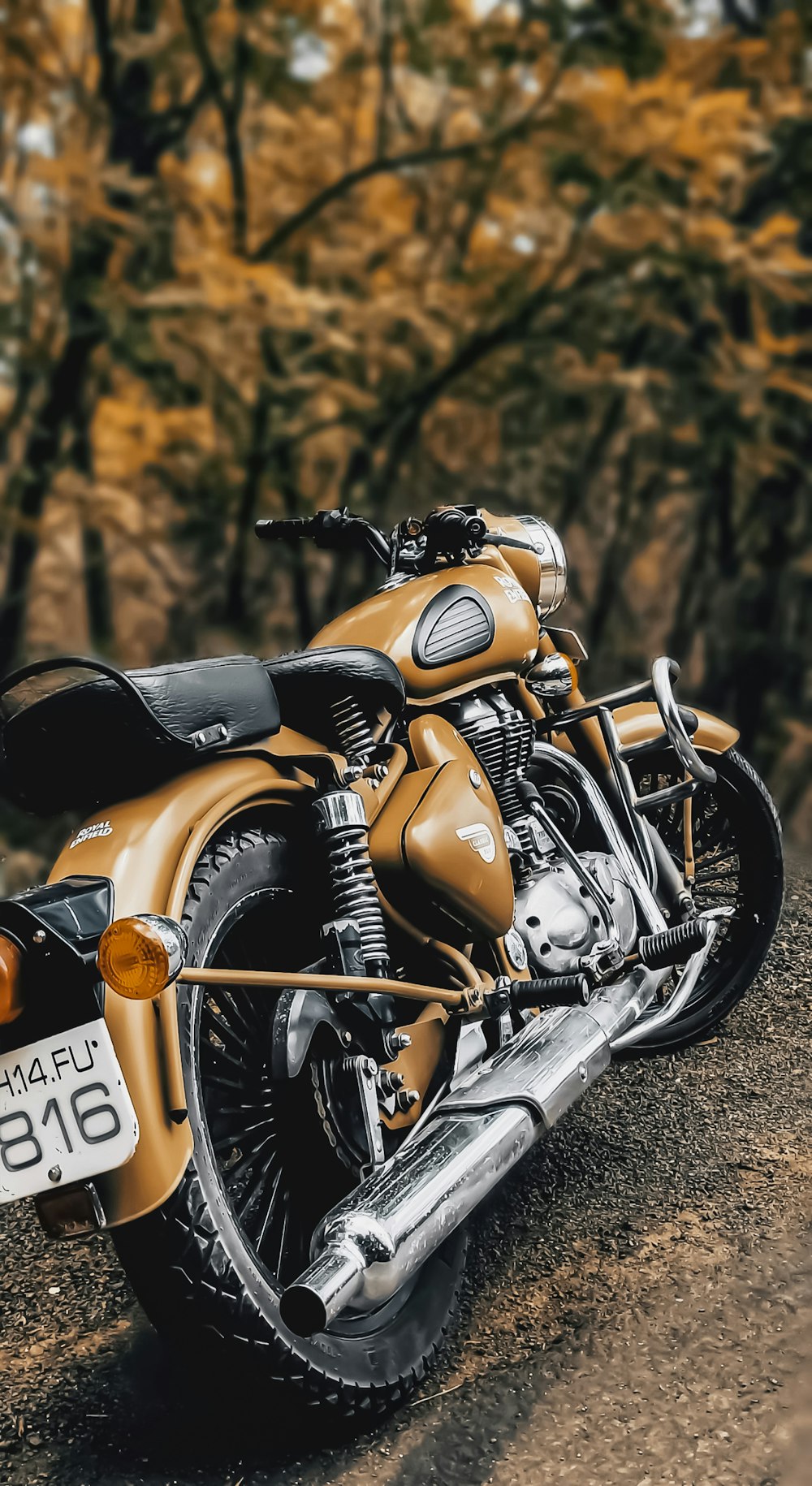 a gold motorcycle parked on the side of a road