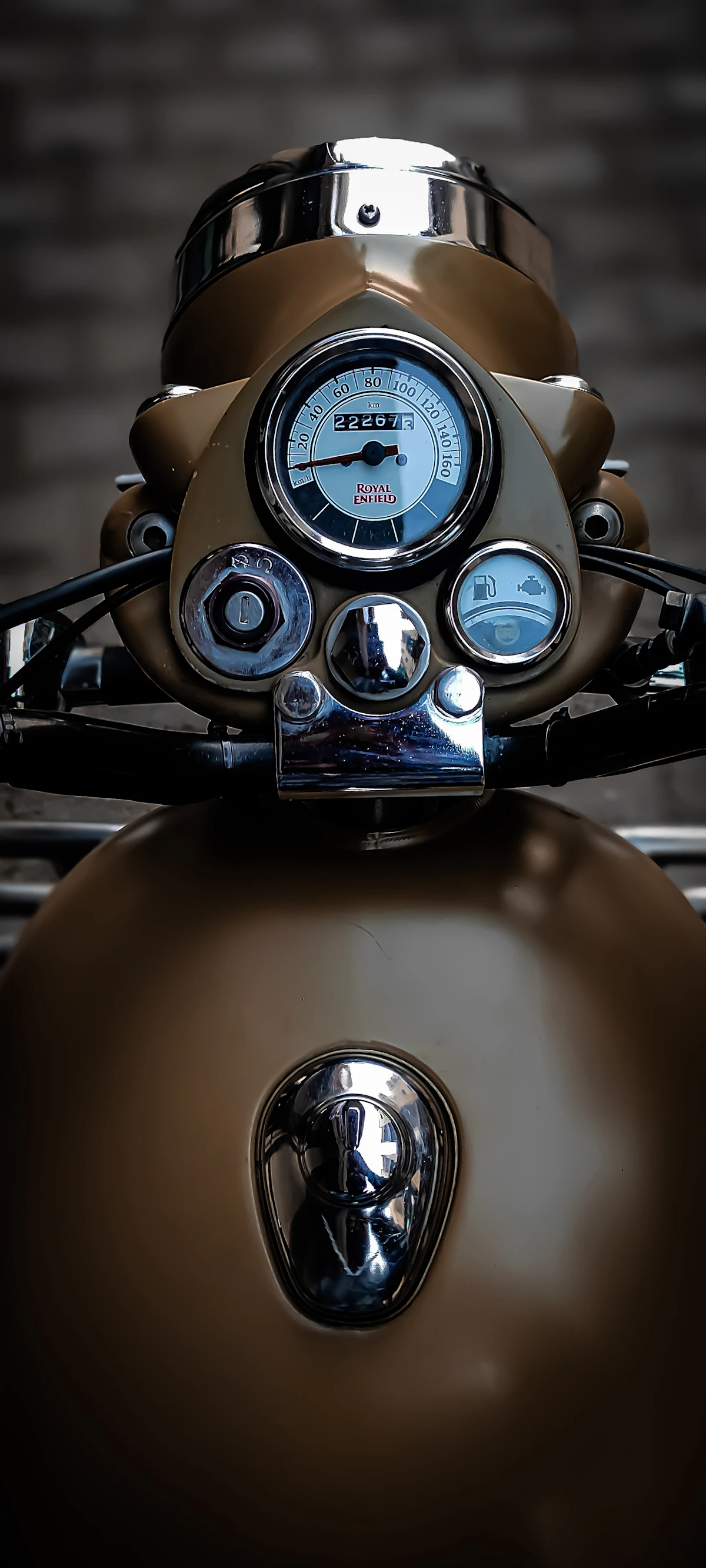 Close view of a motorcycle instrument cluster, speedometer and odometer readable.