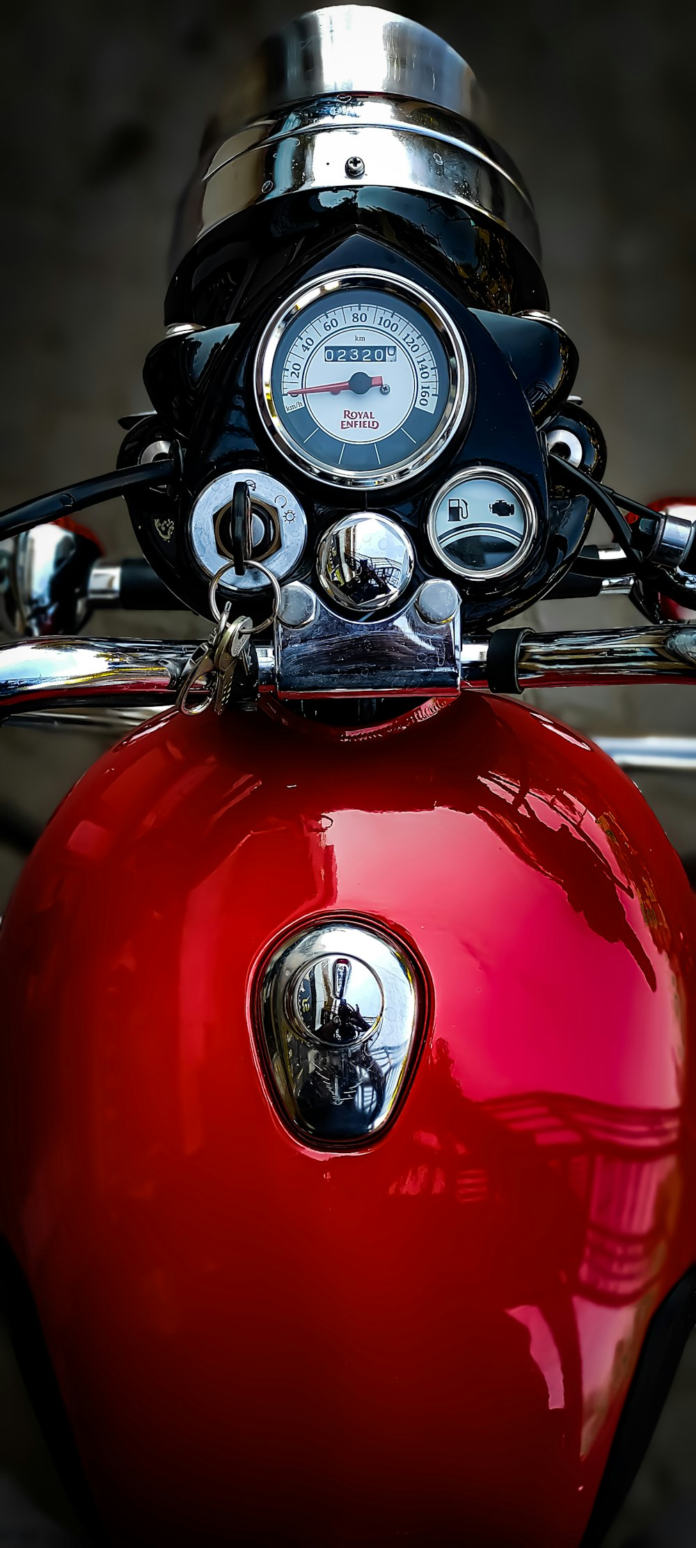 a close up of a red motorcycle with a speedometer