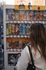 Employee selecting a drink from a modern vending machine