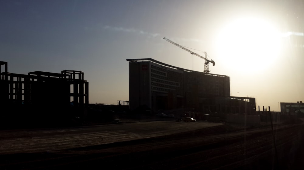 a building under construction with a crane in the background