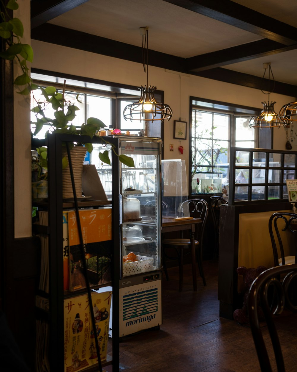 a room with a refrigerator and tables in it