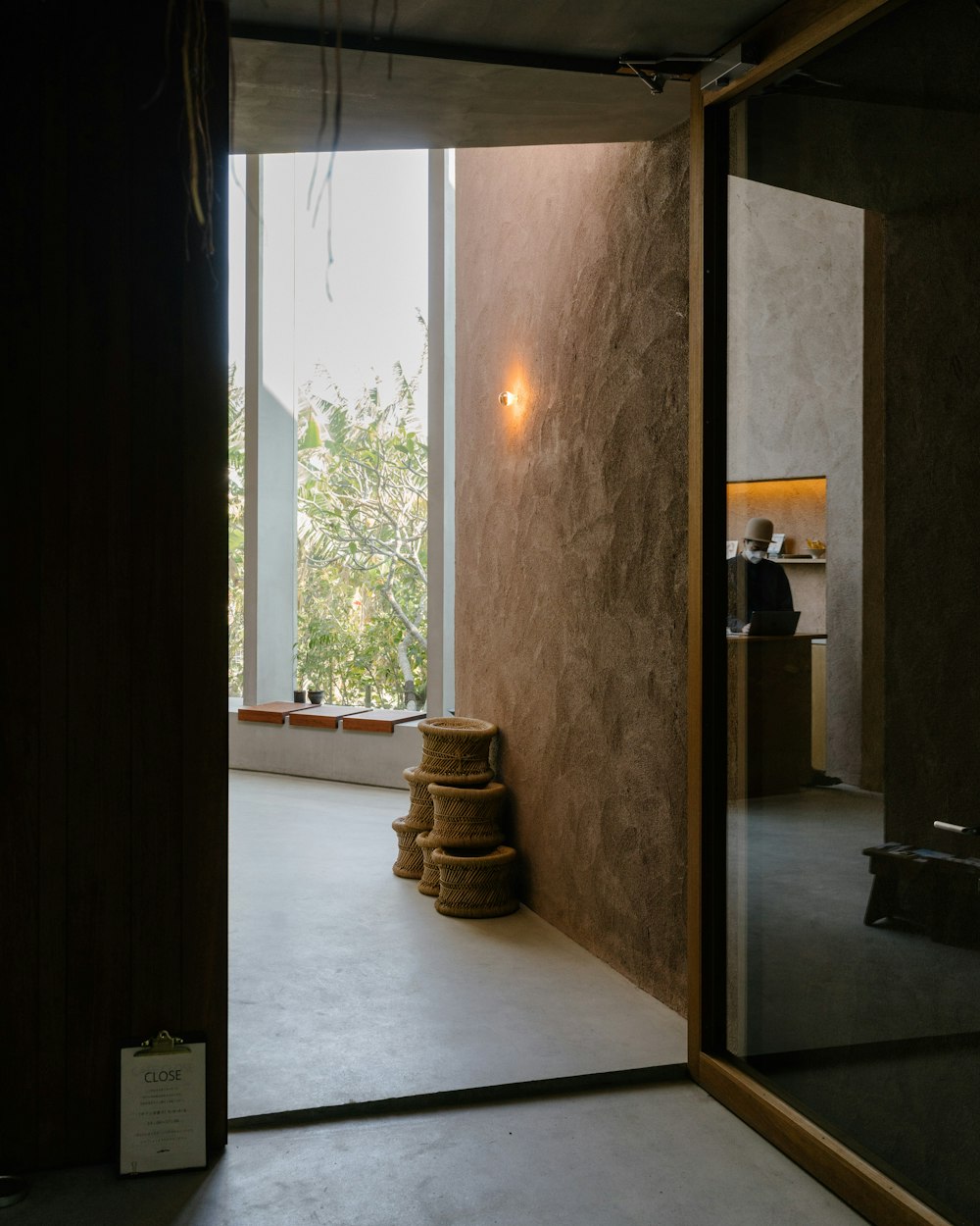 a room with a large window and a stack of stools