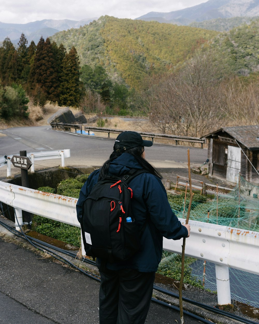 a person with a back pack walking on a bridge