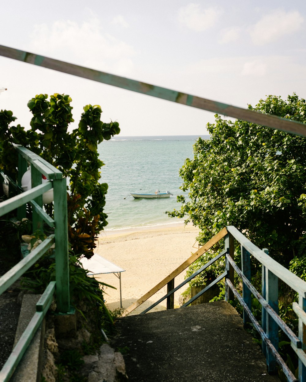 a view of a beach from a set of stairs