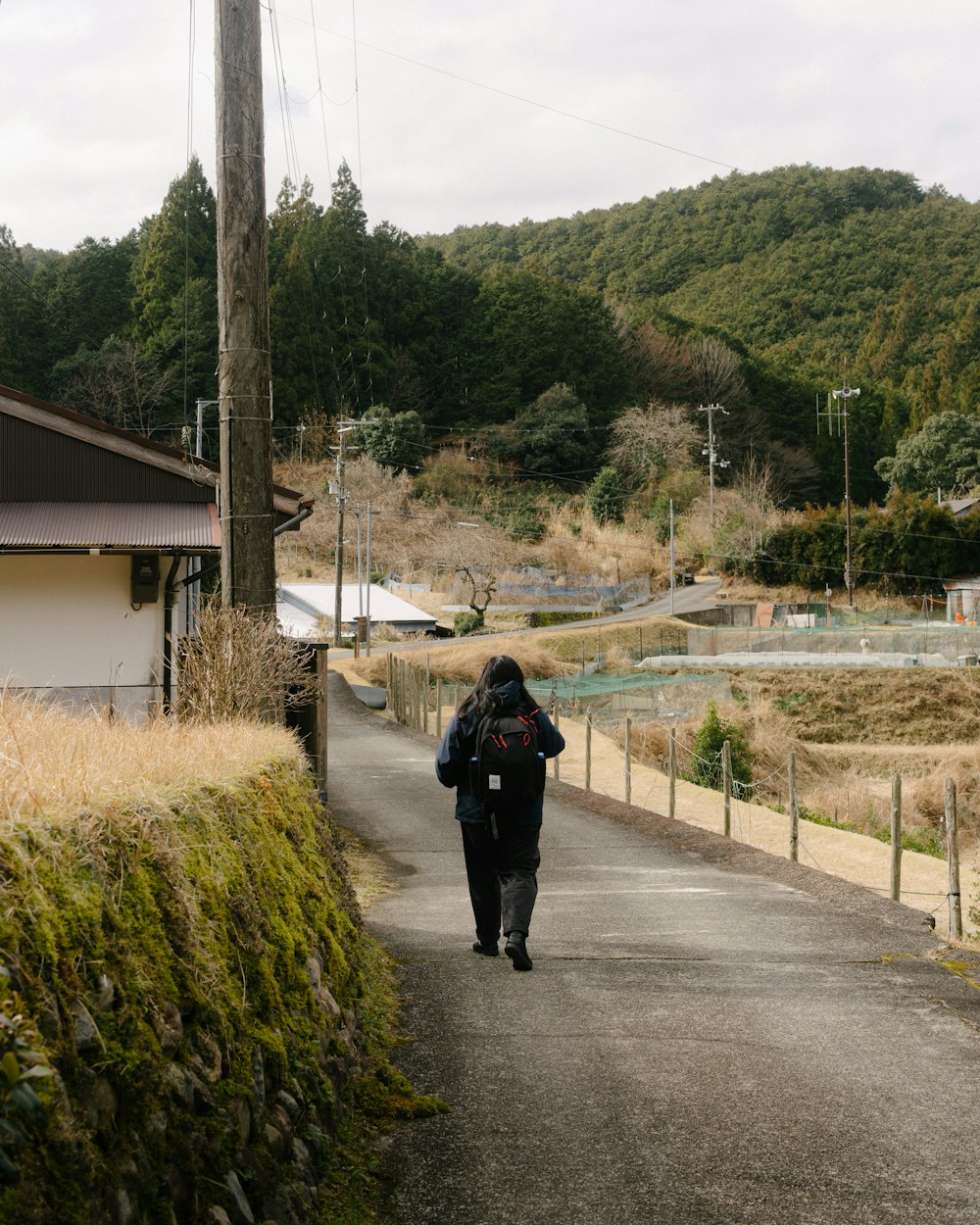 a person walking down a road with a backpack