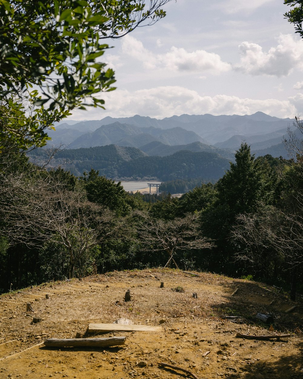 a wooden bench sitting on top of a dirt field