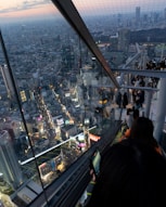a man sitting on top of a tall building