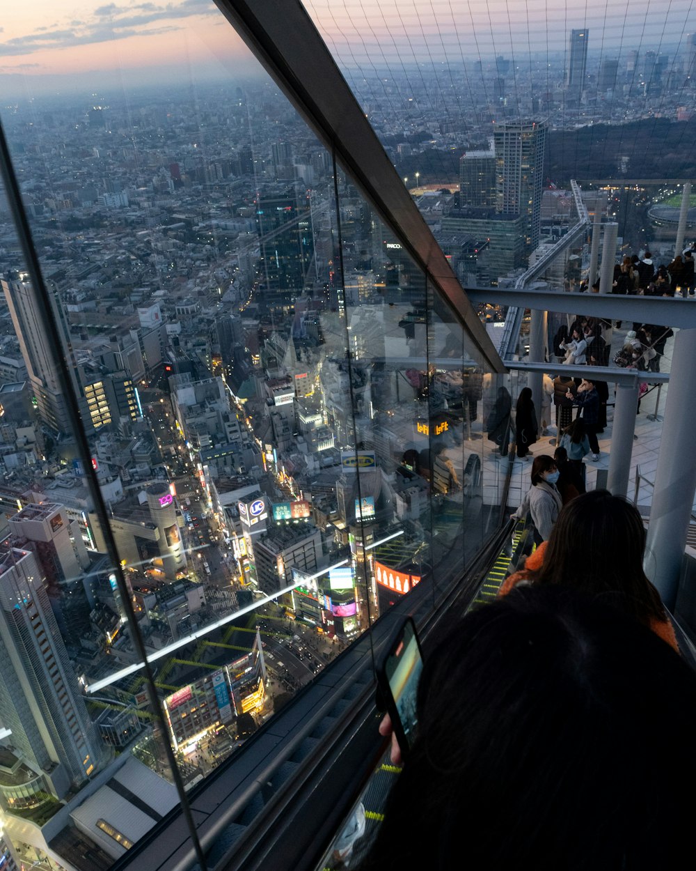 a man sitting on top of a tall building