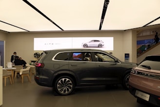 a couple of cars are parked in a showroom