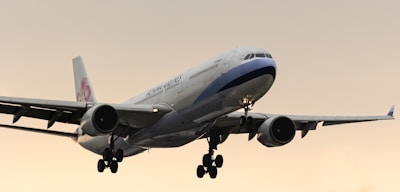 a large jetliner flying through a cloudy sky