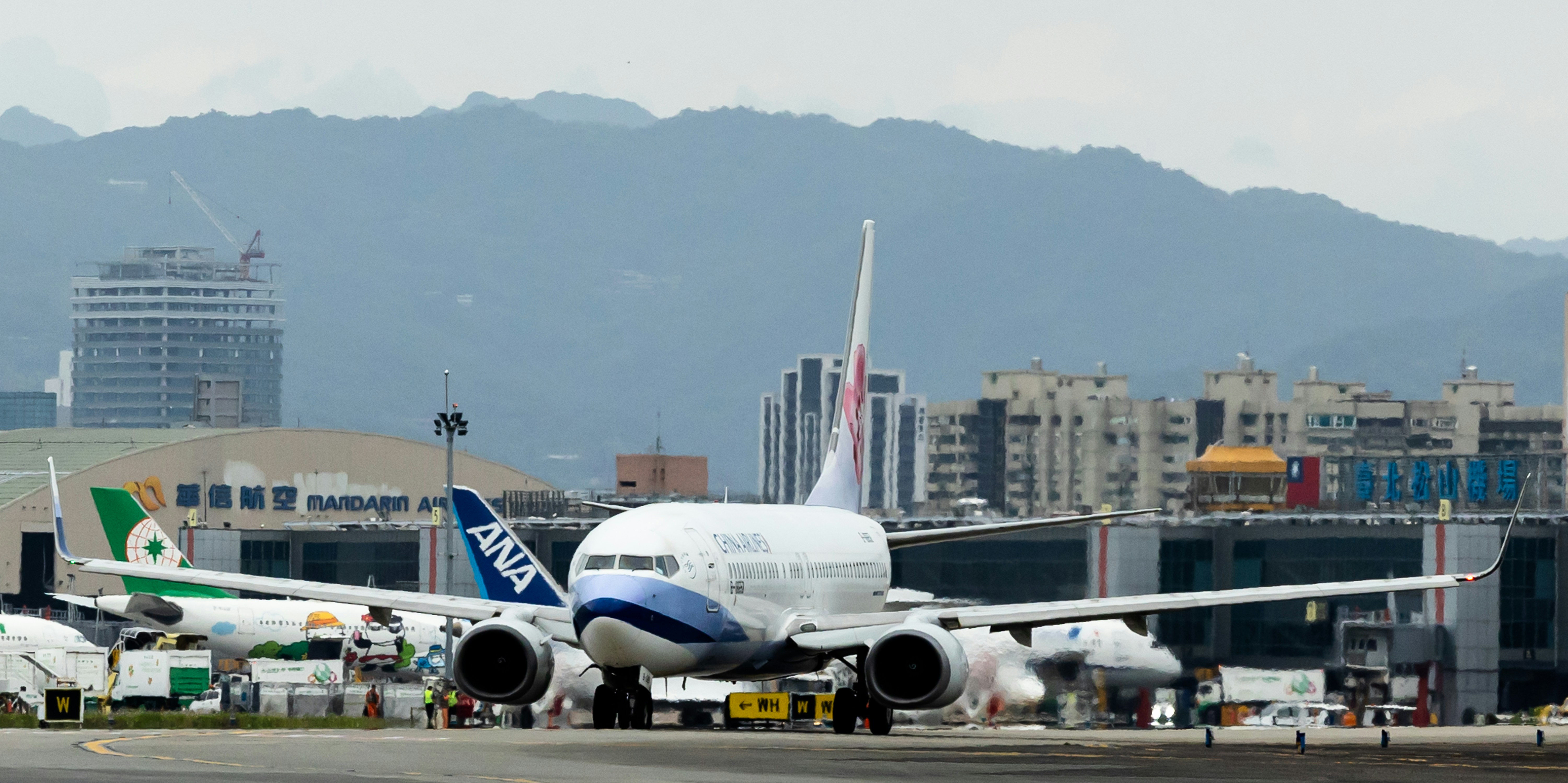 a large jetliner sitting on top of an airport tarmac