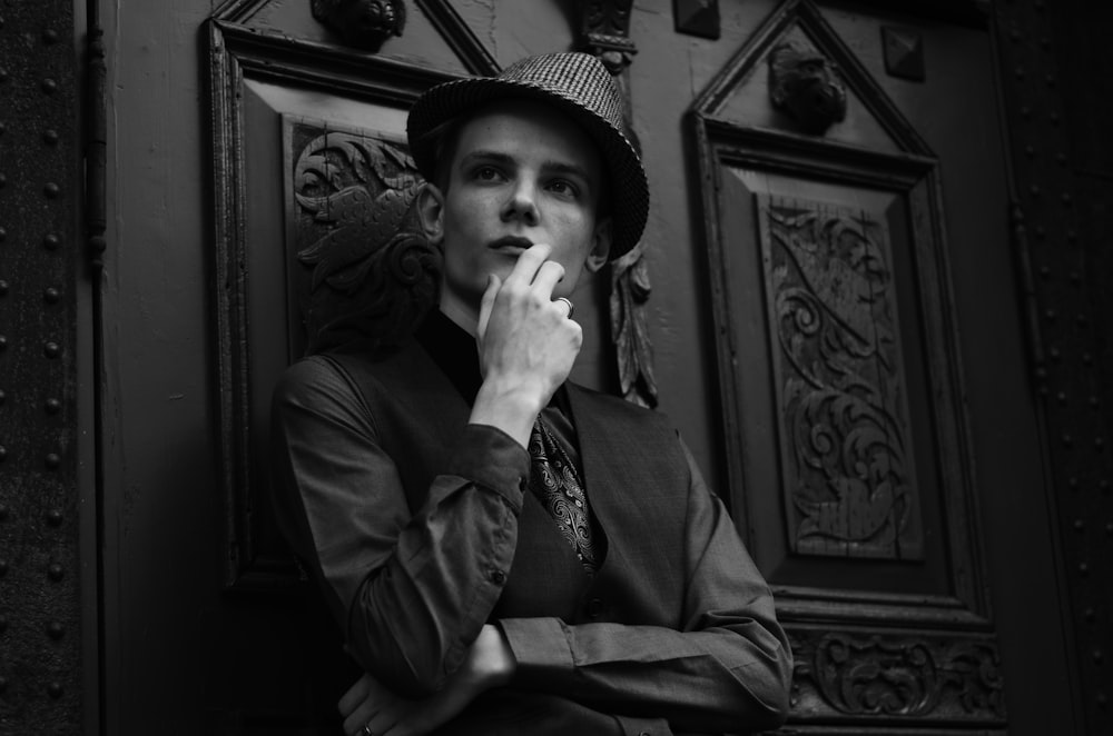 a black and white photo of a man smoking a cigarette