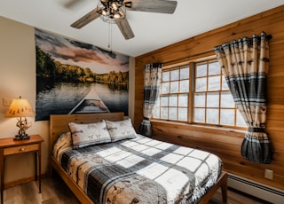 a bed sitting in a bedroom next to a window