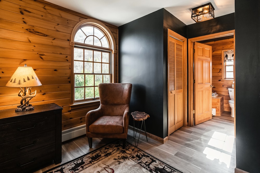 a chair sitting in a room next to a window