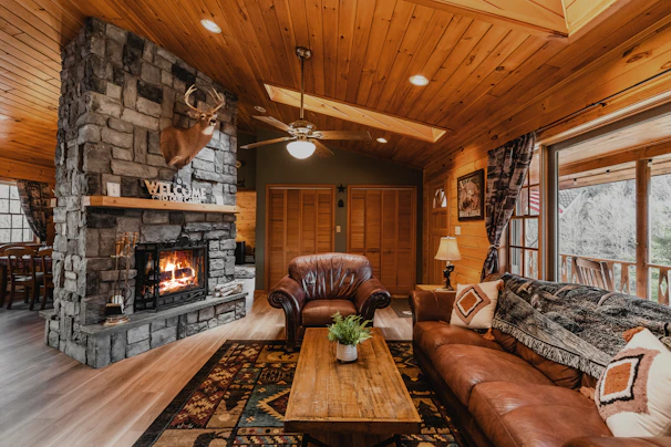 ceiling fan over a living room filled with furniture and a fire place