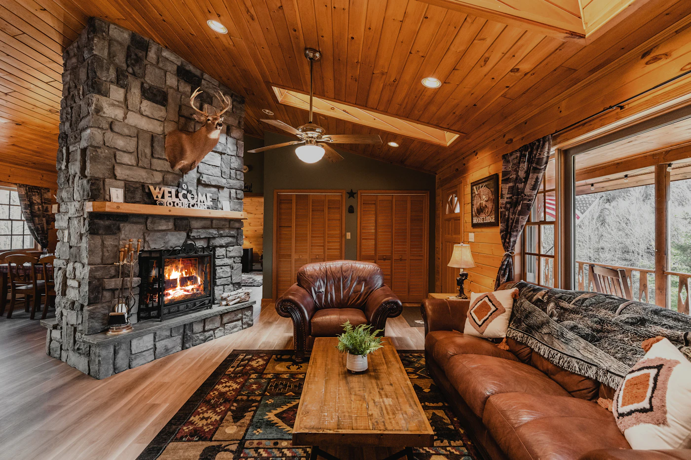 Luxury chalet living room with an open fireplace and timber walls, the case for a chalet over a hotel suite
