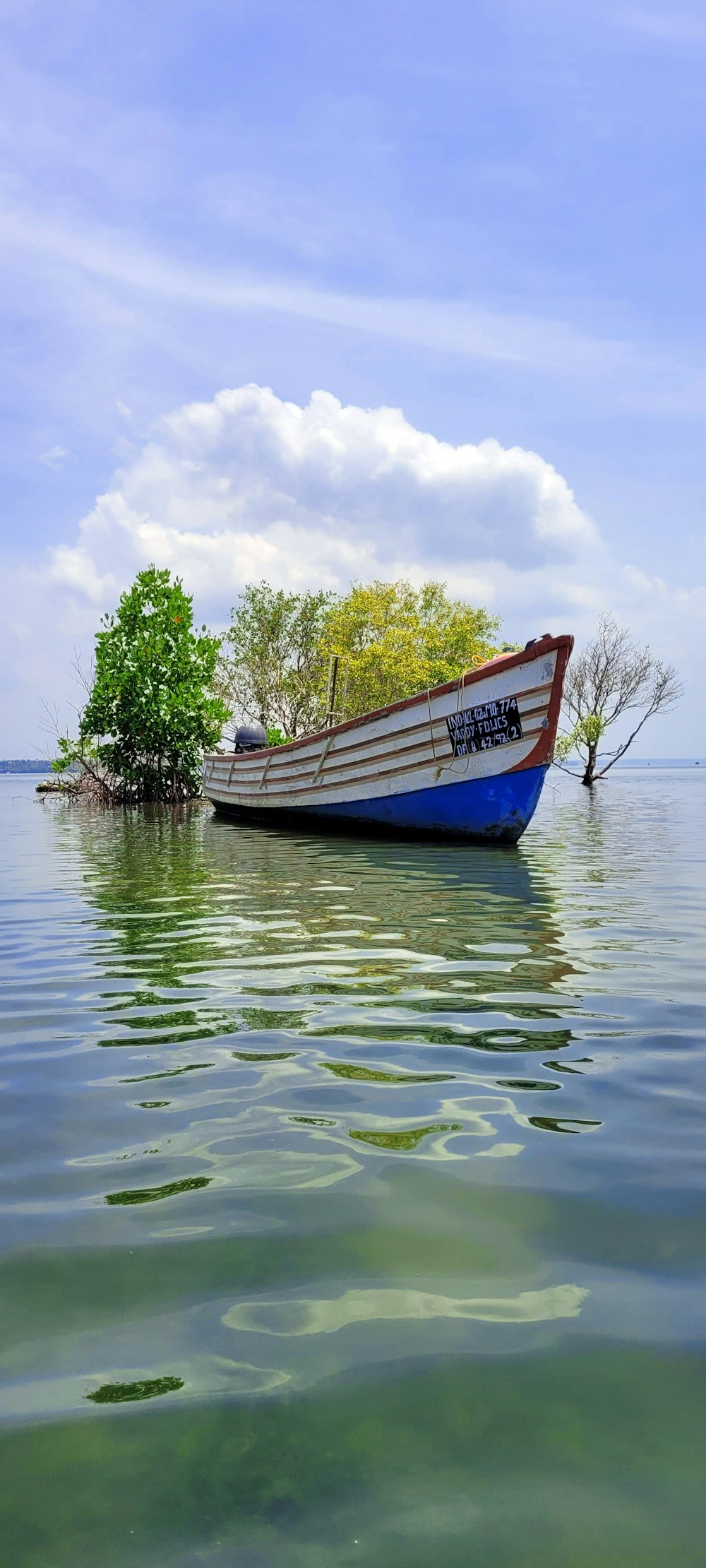 a small boat floating on top of a lake