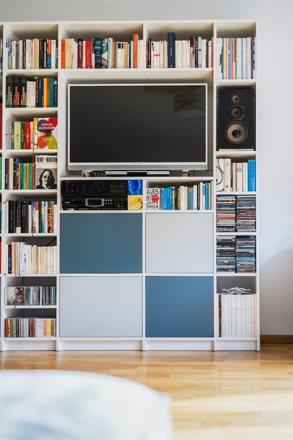 a television is on top of a bookshelf