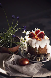 A festive table decorated with candles and flowers, featuring dulcevela cheesecakes as the centerpiece dessert