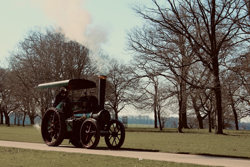 a tractor is driving down the road in a park