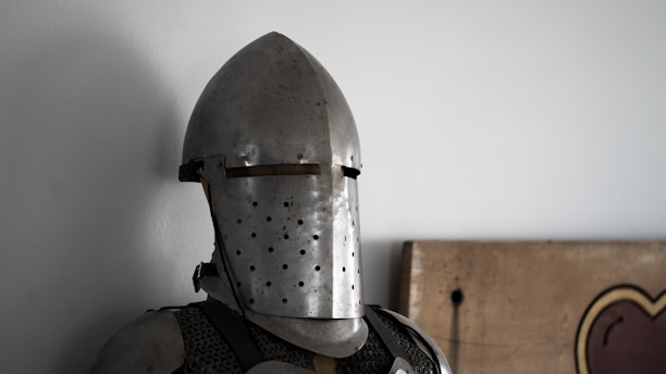 a knight's helmet and armor on display in a room