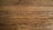 Wooden floor planks with visible grain and texture, featuring some scratches and imperfections.