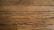 Wooden floor planks with visible grain and texture, featuring some scratches and imperfections.