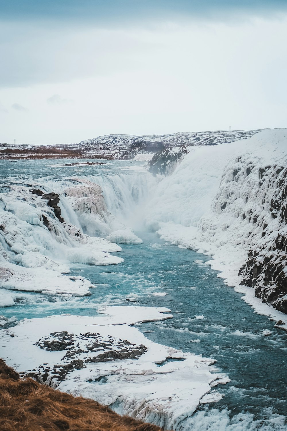 a river flowing through a snow covered landscape